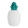 lampe d'ambiance en porcelaine blanche en forme d'ananas.